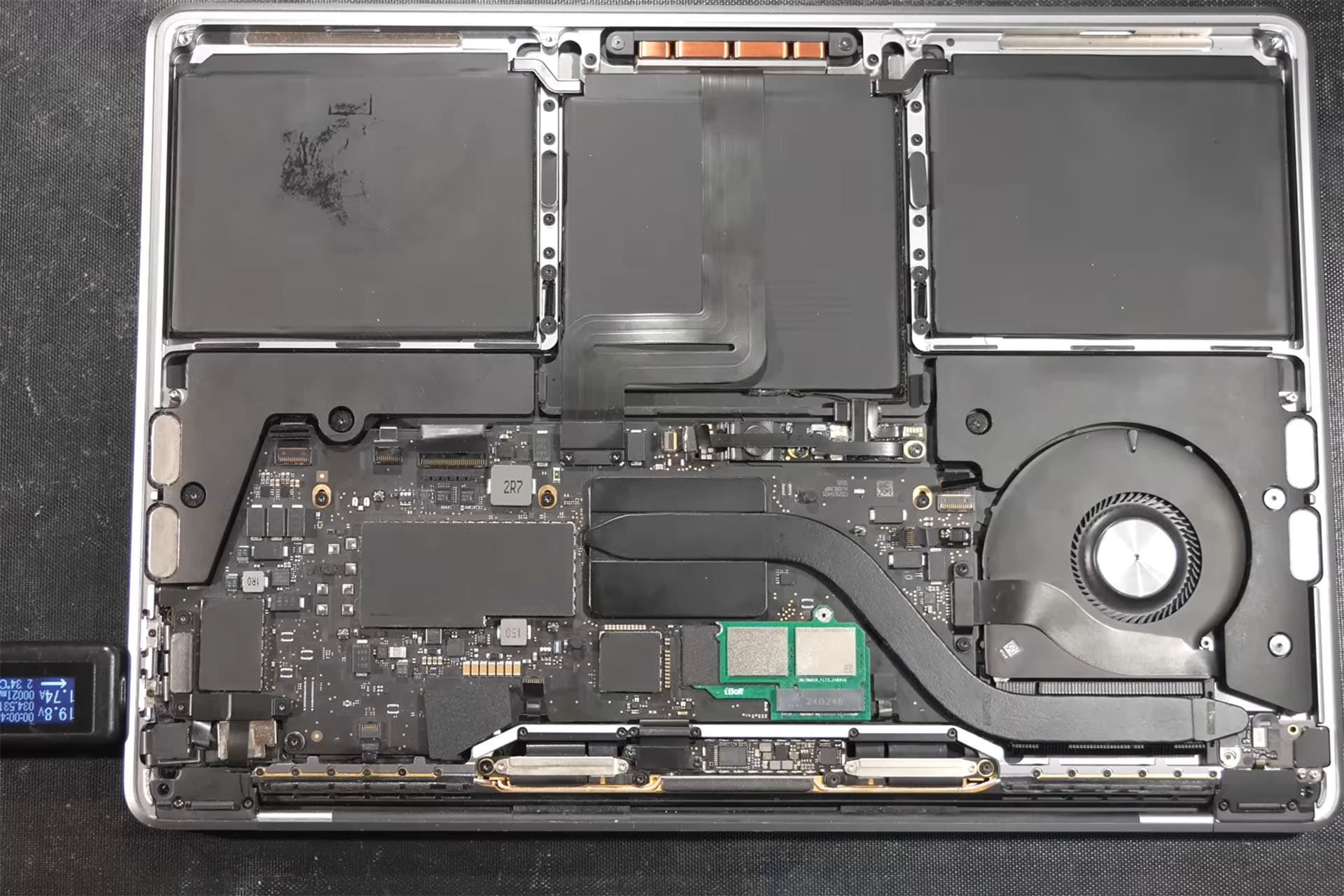 Interior view of an unlocked MacBook with a custom SSD port