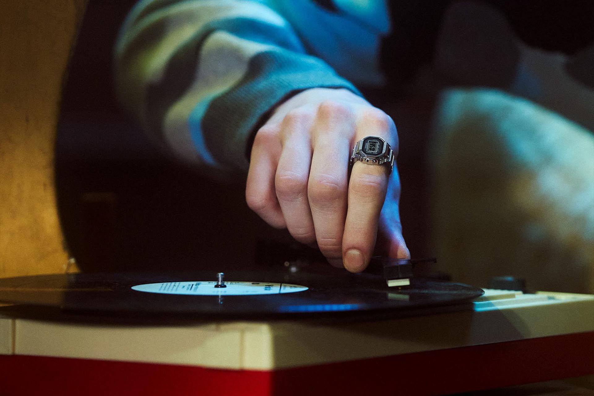 Casio CRW-001-1JR ring in the hand of a person touching the turntable