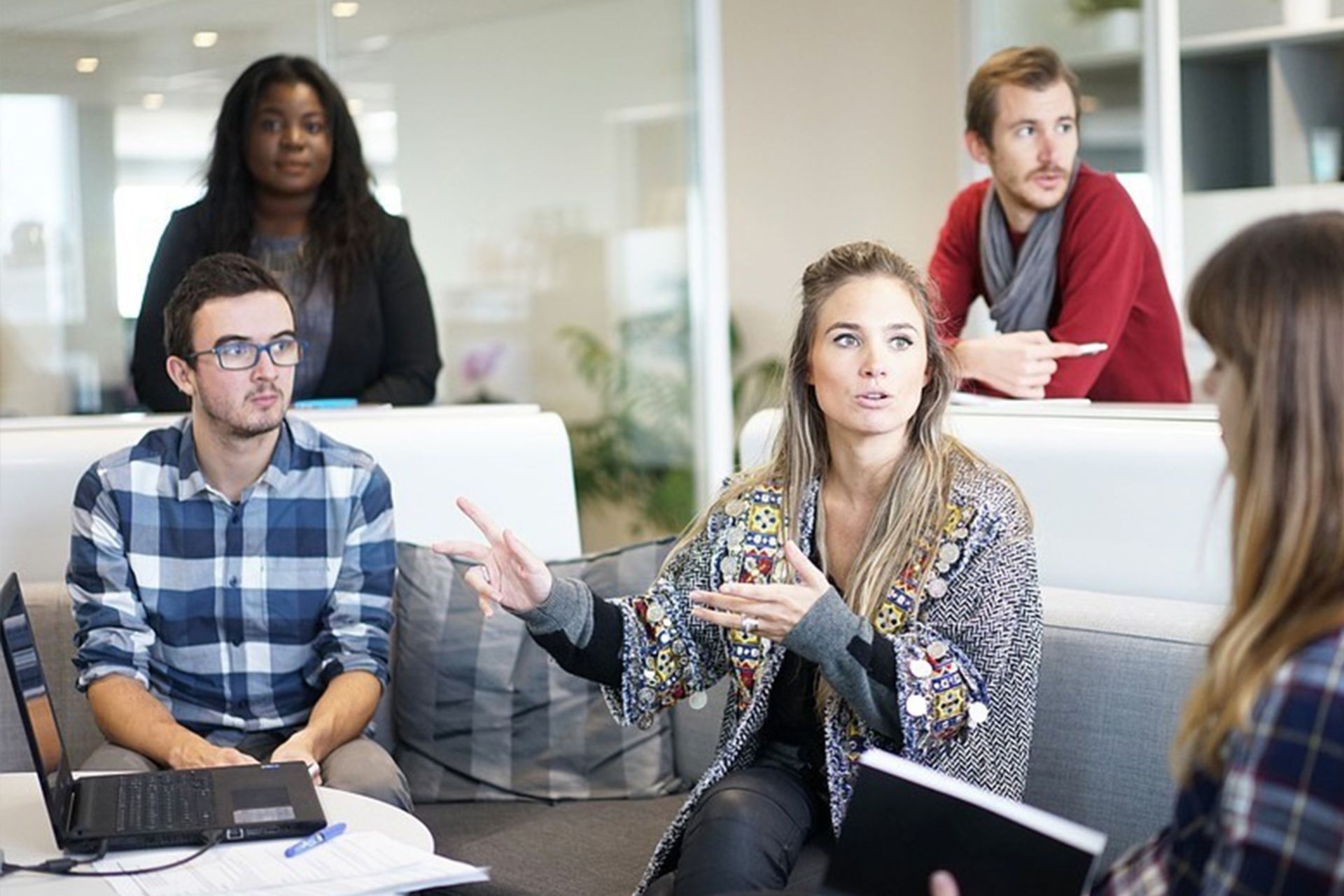 A few men and women next to each other having a business conversation